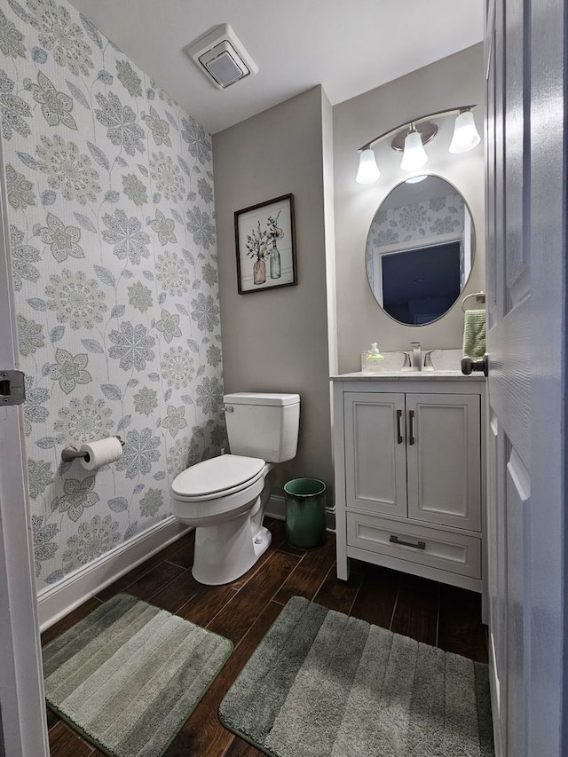 8 W Emerson St, Arlington Heights, IL 60005 - bathroom with wood tiled floors, wallpapered walls, toilet, vanity, and baseboards