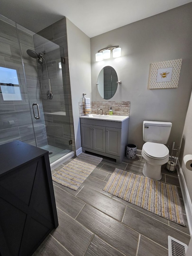 8 W Emerson St, Arlington Heights, IL 60005 - bathroom with a shower stall, toilet, baseboards, and vanity