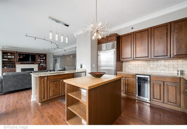 21 E Huron St Unit 3204, Chicago, IL 60611 - kitchen featuring beverage cooler, stainless steel appliances, a sink, a center island, and a chandelier
