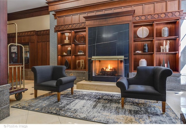 21 E Huron St Unit 3204, Chicago, IL 60611 - living area featuring a warm lit fireplace, tile patterned flooring, crown molding, and built in features