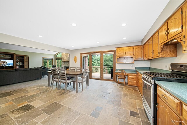 14801 Jean Ct, Oak Forest, IL 60452 - kitchen with stainless steel gas range oven, recessed lighting, stone tile flooring, brown cabinetry, and open floor plan