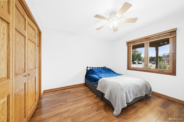 14801 Jean Ct, Oak Forest, IL 60452 - bedroom featuring baseboards, light wood finished floors, a ceiling fan, and a closet