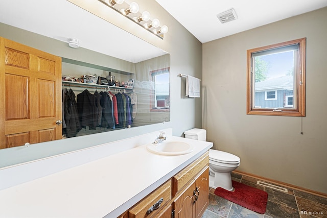 14801 Jean Ct, Oak Forest, IL 60452 - bathroom featuring stone finish flooring, toilet, baseboards, and vanity