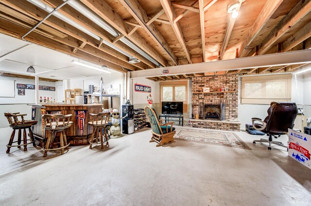 14801 Jean Ct, Oak Forest, IL 60452 - living room featuring concrete floors, a brick fireplace, and a bar