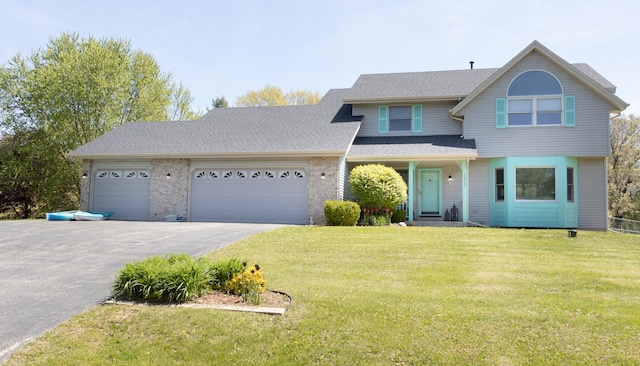 12367 Squirrel Tree Ln, Belvidere, IL 61008 - view of front of house with asphalt driveway, an attached garage, a front yard, and a shingled roof