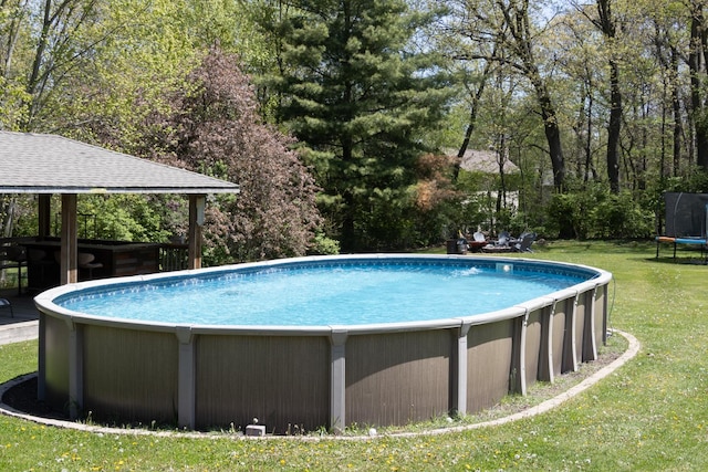 12367 Squirrel Tree Ln, Belvidere, IL 61008 - swimming pool featuring a trampoline and a yard
