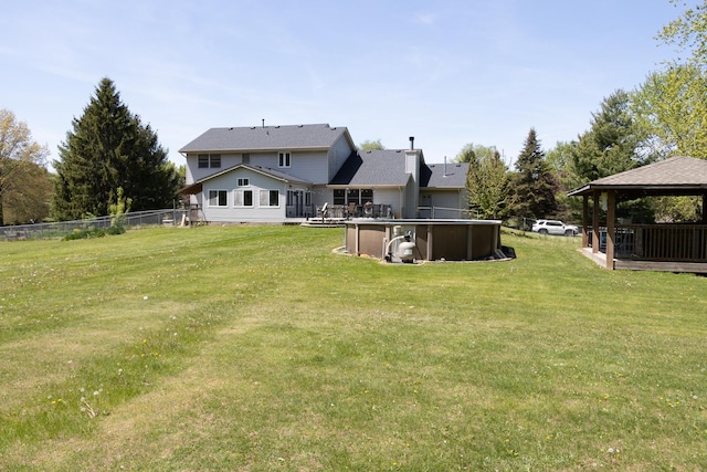 12367 Squirrel Tree Ln, Belvidere, IL 61008 - back of property featuring a gazebo, an outdoor pool, a deck, and a chimney