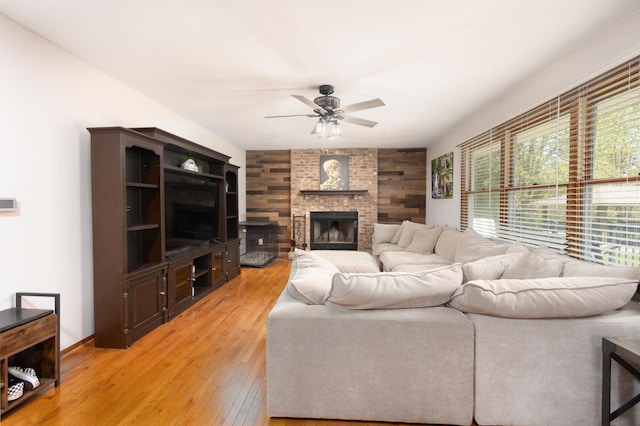 12367 Squirrel Tree Ln, Belvidere, IL 61008 - living area featuring a ceiling fan, light wood-type flooring, and a fireplace