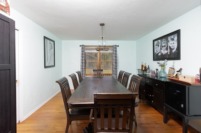 12367 Squirrel Tree Ln, Belvidere, IL 61008 - dining room featuring light wood finished floors, a chandelier, and baseboards