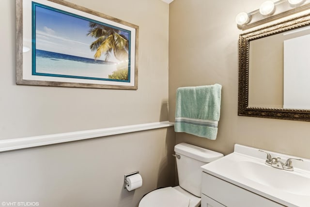 bathroom featuring vanity and toilet