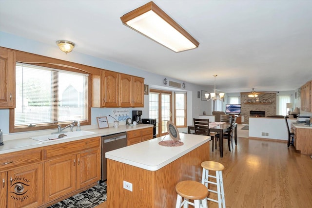 975 S Laura Ln, Coal City, IL 60416 - kitchen with stainless steel dishwasher, a sink, open floor plan, a kitchen bar, and light countertops