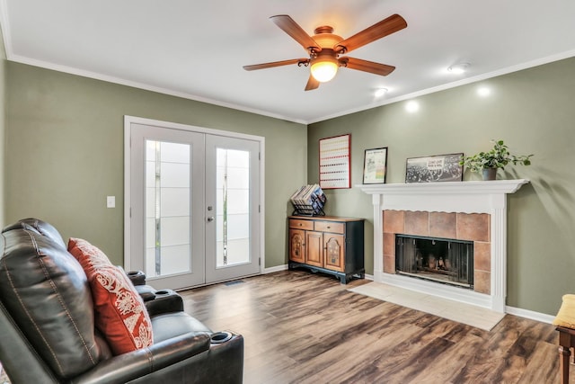 1723 Victor Ter, Gurnee, IL 60031 - living room featuring french doors, wood finished floors, ornamental molding, ceiling fan, and a tile fireplace