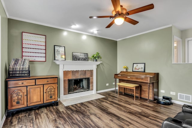 1723 Victor Ter, Gurnee, IL 60031 - living area featuring wood finished floors, baseboards, ceiling fan, a tiled fireplace, and crown molding