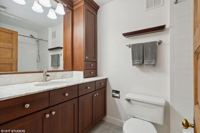 bathroom featuring a shower, toilet, baseboards, tile patterned flooring, and vanity
