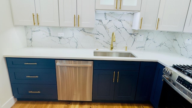 527 Northgate Rd, Lindenhurst, IL 60046 - kitchen featuring appliances with stainless steel finishes, a sink, blue cabinets, and white cabinets