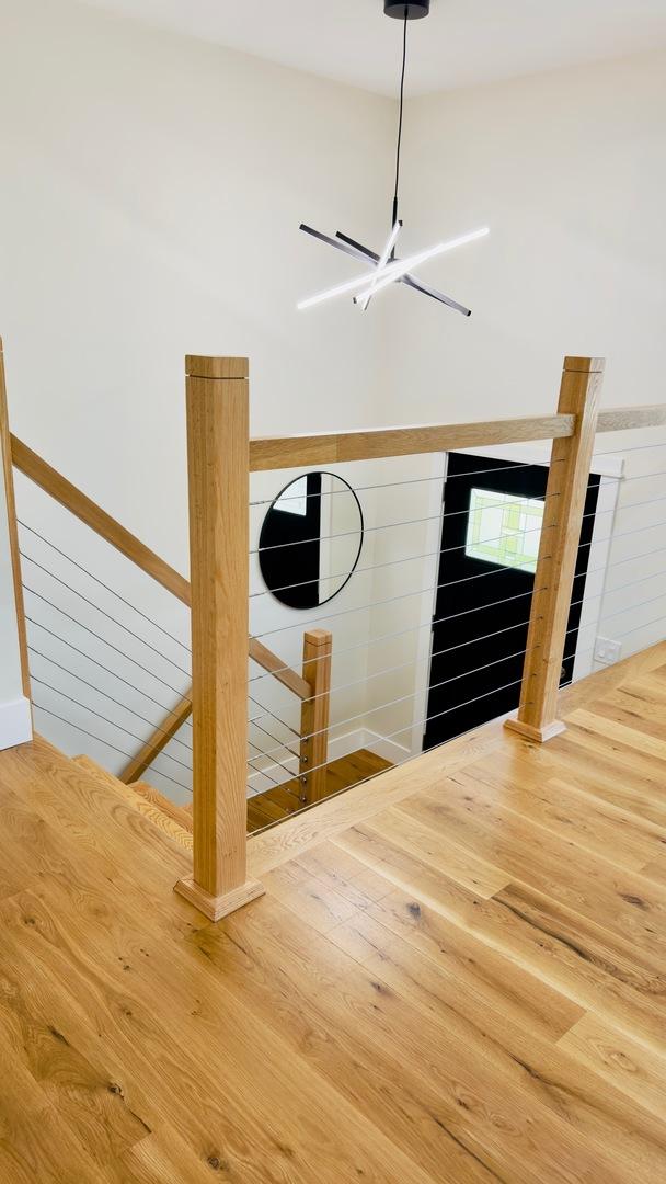527 Northgate Rd, Lindenhurst, IL 60046 - detailed view of wood finished floors, a chandelier, and baseboards