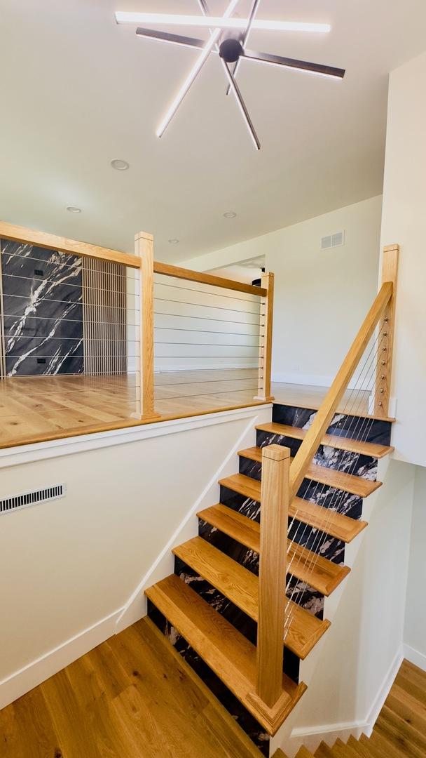 527 Northgate Rd, Lindenhurst, IL 60046 - stairs featuring wood finished floors and baseboards