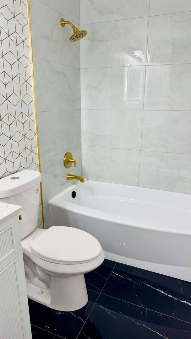 527 Northgate Rd, Lindenhurst, IL 60046 - bathroom featuring marble finish floors, toilet, shower / washtub combination, and vanity