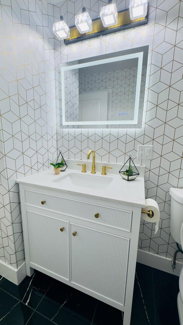 527 Northgate Rd, Lindenhurst, IL 60046 - bathroom featuring tile walls, tile patterned flooring, vanity, and toilet