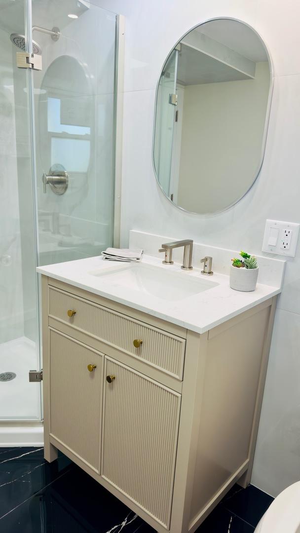 527 Northgate Rd, Lindenhurst, IL 60046 - bathroom with a stall shower, vanity, and toilet