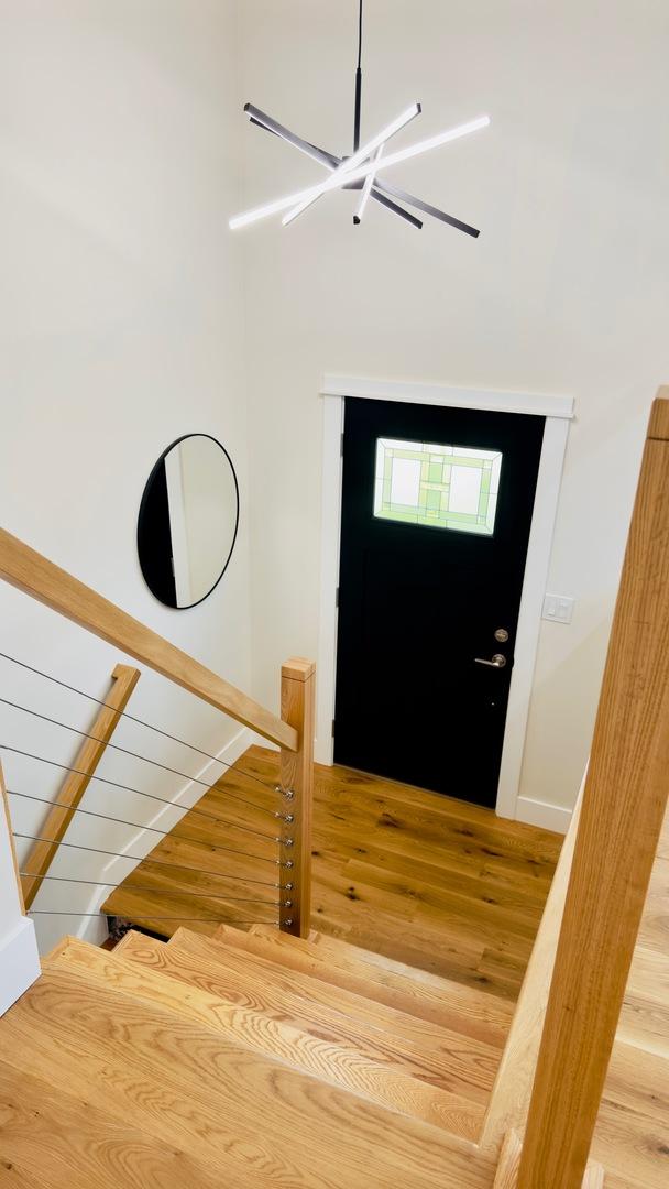 527 Northgate Rd, Lindenhurst, IL 60046 - entrance foyer featuring wood finished floors, a chandelier, baseboards, and stairway