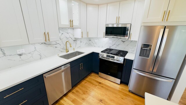 527 Northgate Rd, Lindenhurst, IL 60046 - kitchen with stainless steel appliances, a sink, white cabinetry, and blue cabinetry