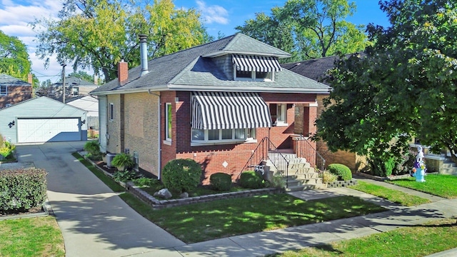 bungalow-style house with brick siding, an outdoor structure, a garage, a front lawn, and a chimney