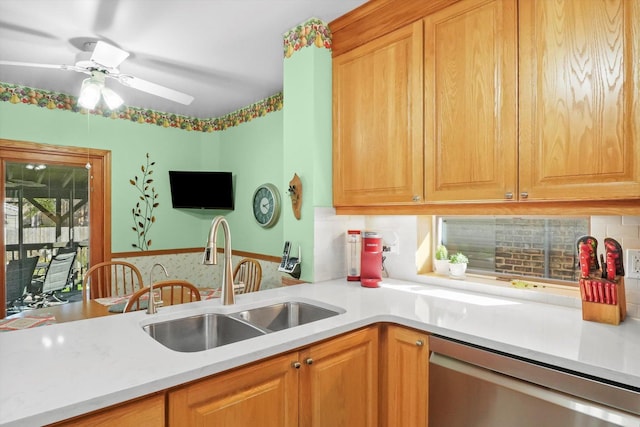 kitchen featuring dishwasher, a sink, light countertops, and ceiling fan