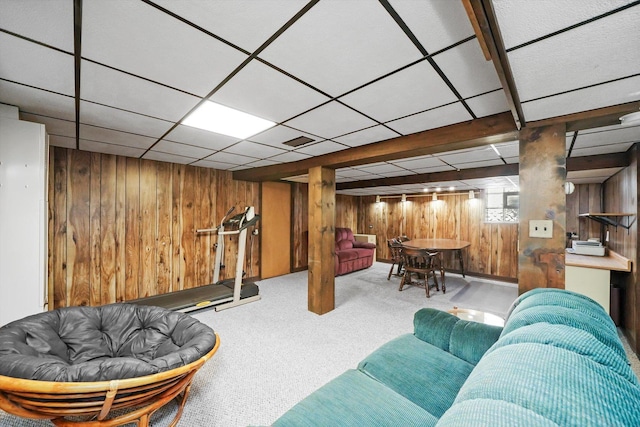 carpeted living area with wooden walls