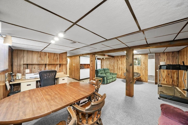 carpeted home office with wood walls