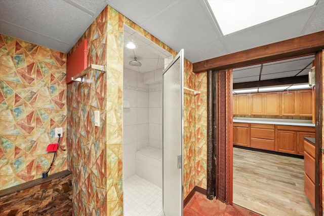 full bathroom featuring a shower stall and wood finished floors
