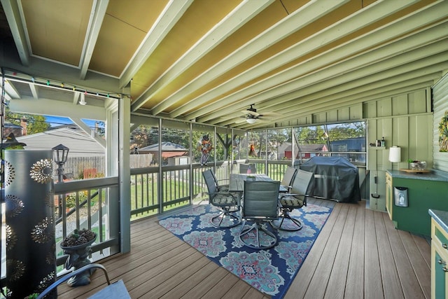 wooden terrace featuring outdoor dining space, fence, and a grill