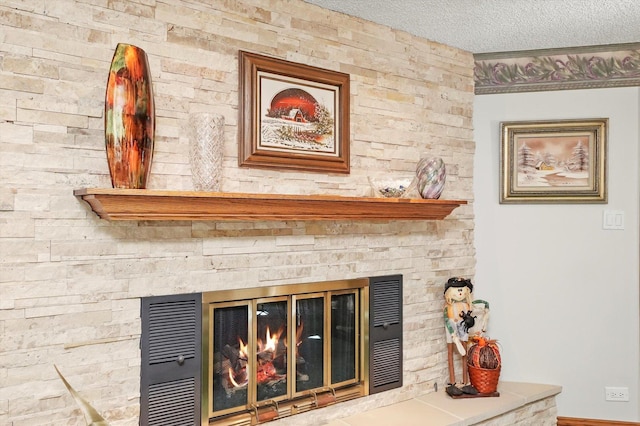 detailed view of a fireplace and a textured ceiling