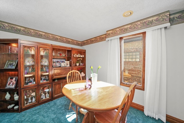 dining room with carpet floors and a textured ceiling