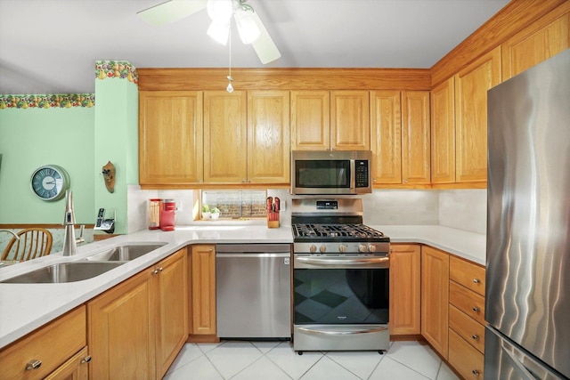 kitchen featuring appliances with stainless steel finishes, a sink, and light countertops