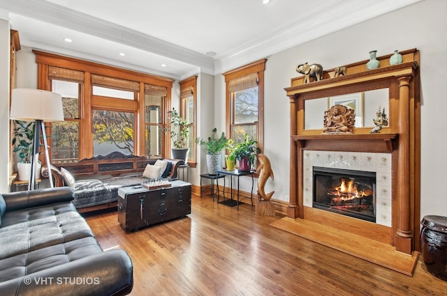 4752 N Beacon St, Chicago, IL 60613 - living room with wood finished floors, a tile fireplace, ornamental molding, and recessed lighting