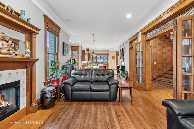 4752 N Beacon St, Chicago, IL 60613 - living area with wood finished floors, ornamental molding, a fireplace, stairs, and recessed lighting