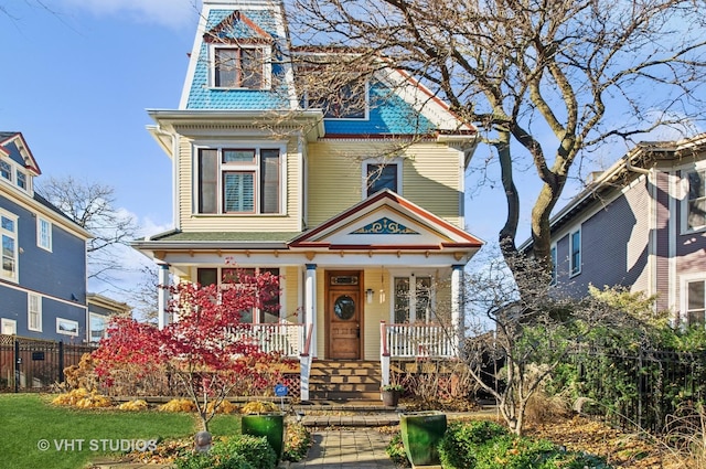 4752 N Beacon St, Chicago, IL 60613 - victorian house featuring a porch and fence