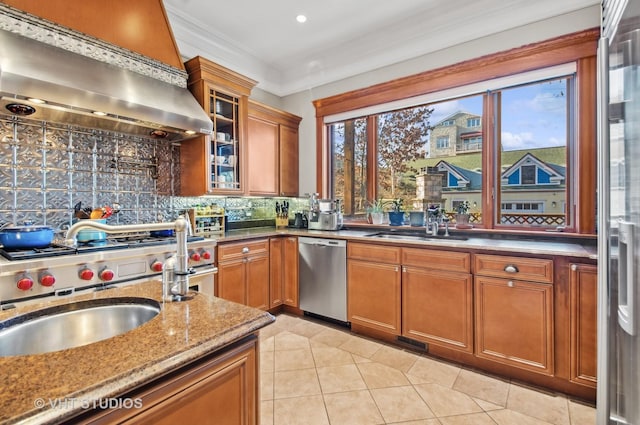 4752 N Beacon St, Chicago, IL 60613 - kitchen featuring wall chimney exhaust hood, dishwasher, a sink, tasteful backsplash, and brown cabinetry