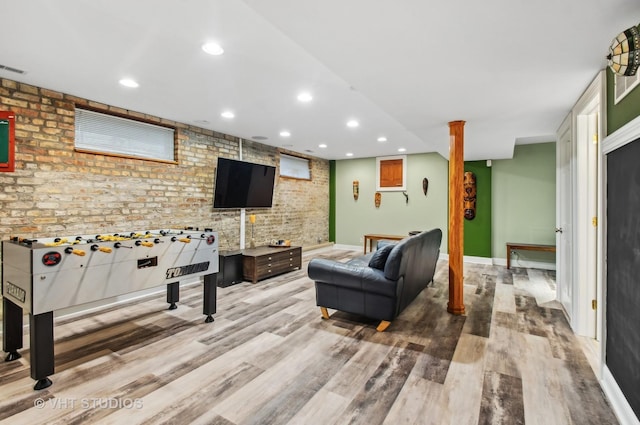 4752 N Beacon St, Chicago, IL 60613 - rec room featuring brick wall, wood finished floors, baseboards, and recessed lighting