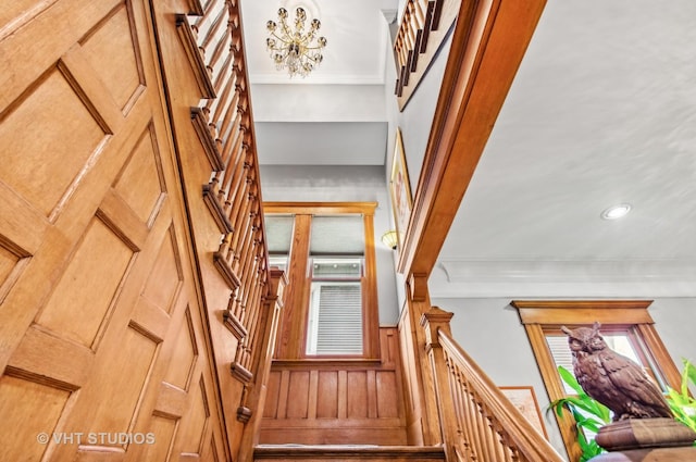 4752 N Beacon St, Chicago, IL 60613 - stairway with a chandelier, ornamental molding, and recessed lighting