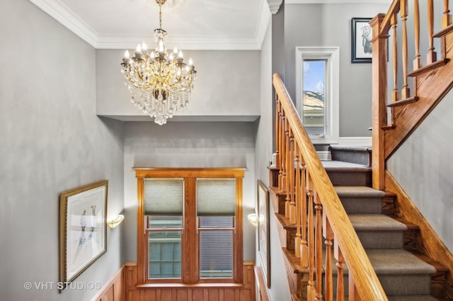 4752 N Beacon St, Chicago, IL 60613 - stairway with a chandelier, crown molding, and a wainscoted wall