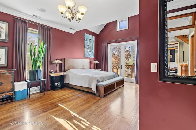 4752 N Beacon St, Chicago, IL 60613 - bedroom with a chandelier, access to exterior, wood finished floors, and lofted ceiling