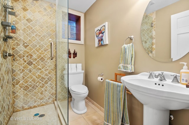 4752 N Beacon St, Chicago, IL 60613 - full bathroom featuring a stall shower, toilet, tile patterned floors, and a sink