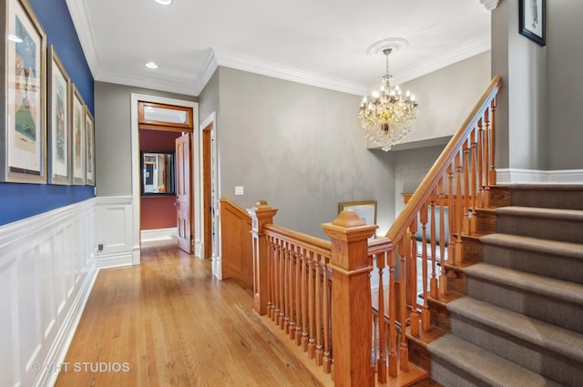 4752 N Beacon St, Chicago, IL 60613 - stairs featuring a chandelier, wood finished floors, recessed lighting, ornamental molding, and wainscoting