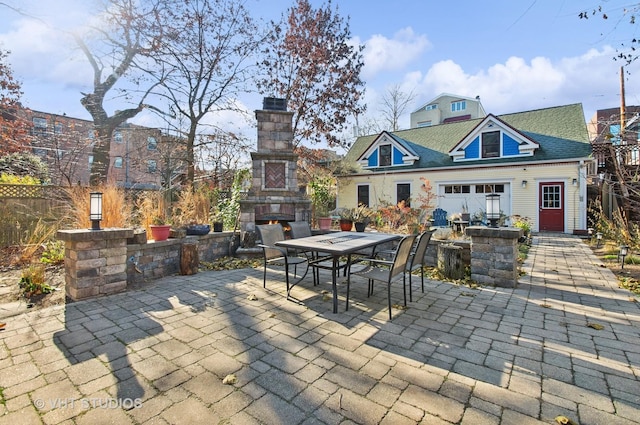 4752 N Beacon St, Chicago, IL 60613 - view of patio / terrace with an outdoor stone fireplace, outdoor dining area, and fence