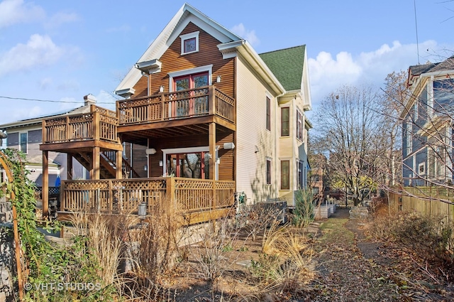 4752 N Beacon St, Chicago, IL 60613 - rear view of property featuring a wooden deck, stairs, and roof with shingles