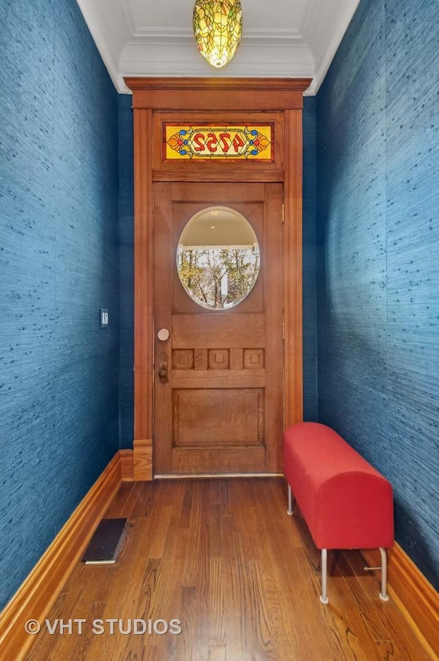 4752 N Beacon St, Chicago, IL 60613 - doorway to outside with wallpapered walls, wood finished floors, ornamental molding, and baseboards
