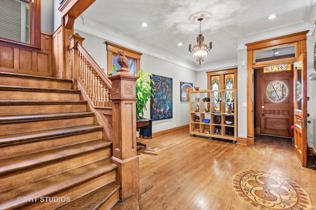 4752 N Beacon St, Chicago, IL 60613 - entrance foyer featuring a chandelier, stairway, baseboards, ornamental molding, and light wood finished floors