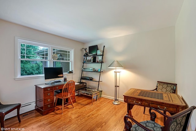 office area with light wood finished floors and baseboards